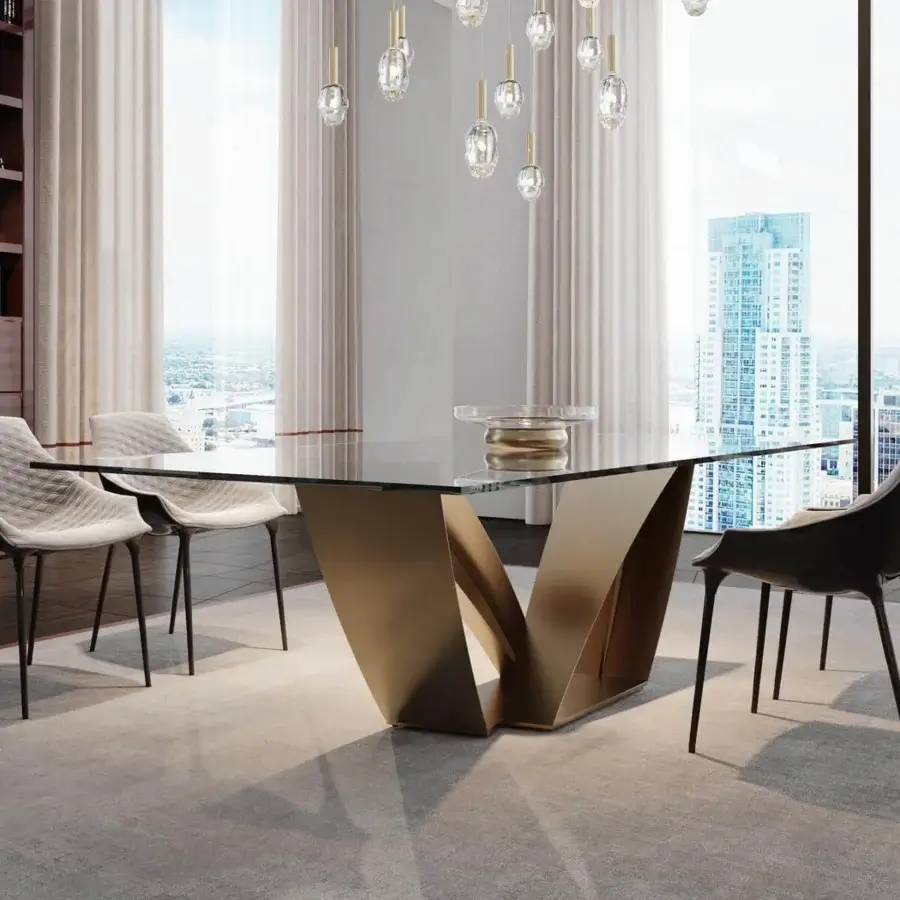 Distinguished Reflex Apeiron table with rectangular glass top and curved iron V-shaped base in bronze or gold toned finish