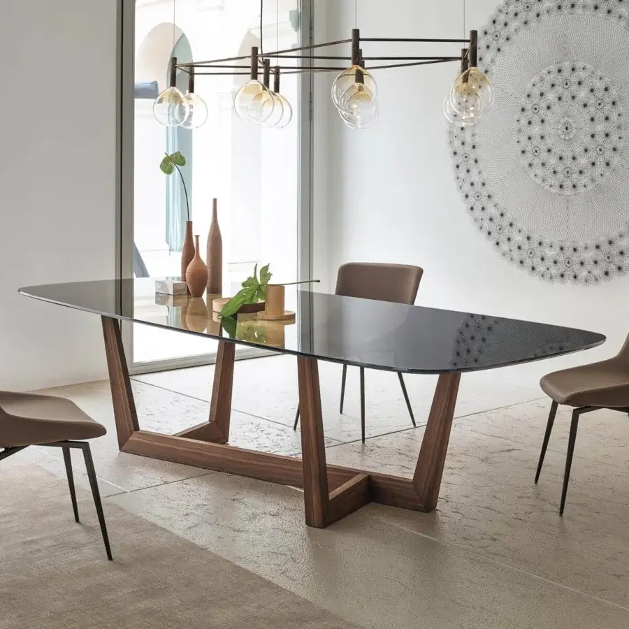 Distinguished Bonaldo Art Wood table with a transparent glass top and sculpted solid American walnut wood trapezoid bases