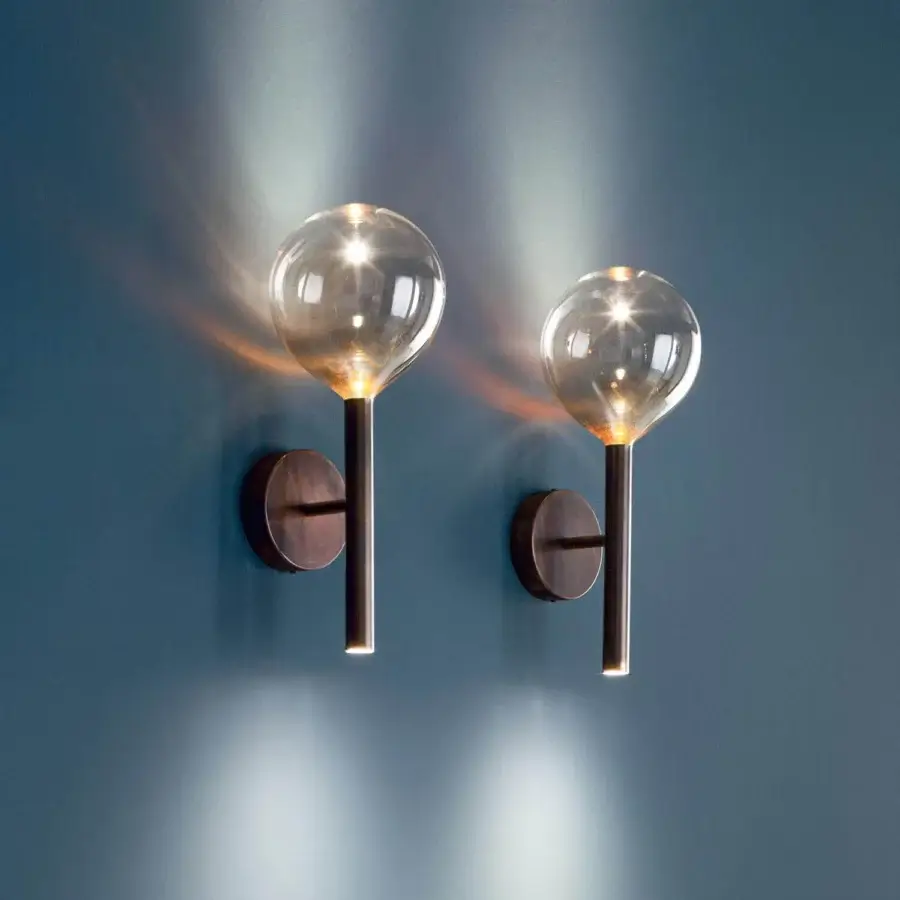 Distinguished Bonaldo Sofi wall lamp with a warm amber borosilicate glass globe and burnished brass cylinder