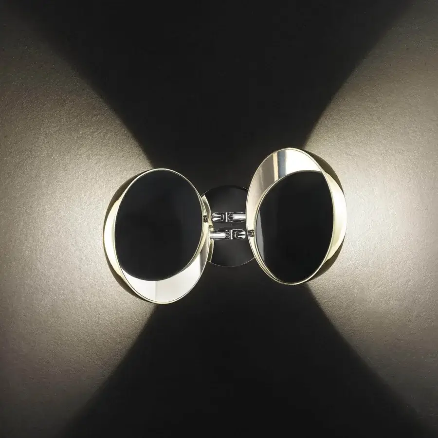 Exclusive Lodes Nautilus wall lamp with oval lamps and polished metal creating a warm reflected glow