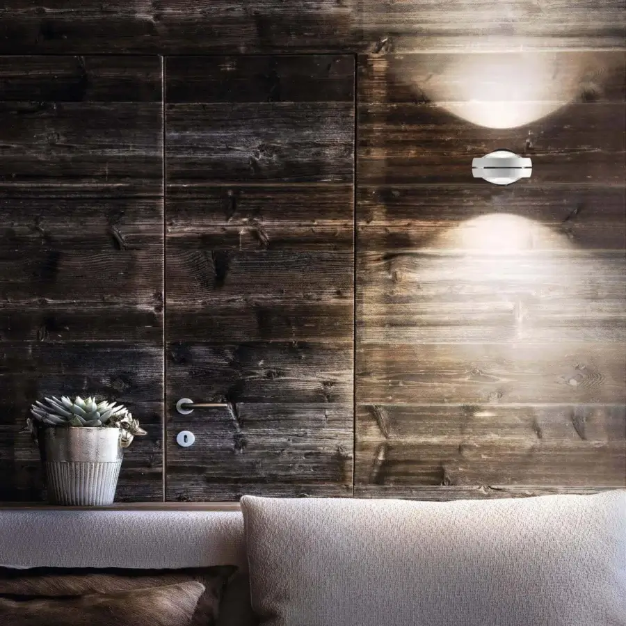 Elegant Lodes Nautilus wall lamp carries modern Italian style with a glossy silver metal finish projecting a bright halo