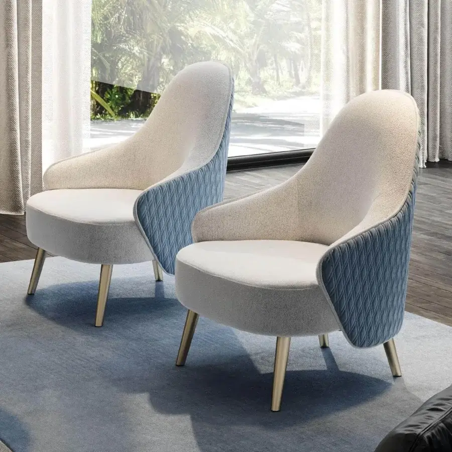 Refined Reflex Ludwig lounge chair with quilted blue textile and light speckled interior upholstery, built with glossy metal legs