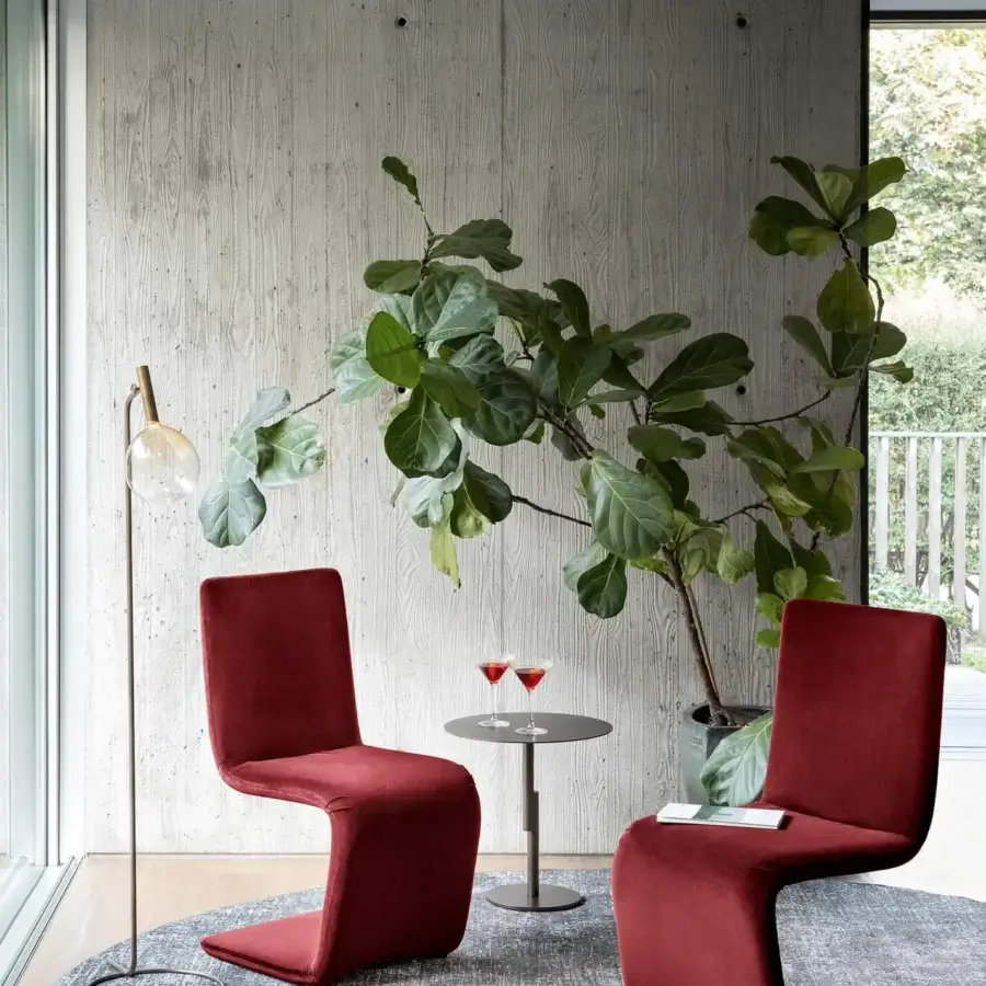 Elegant Bonaldo Venere chair with curved lines and fully upholstered form in deep red textile with matte finish
