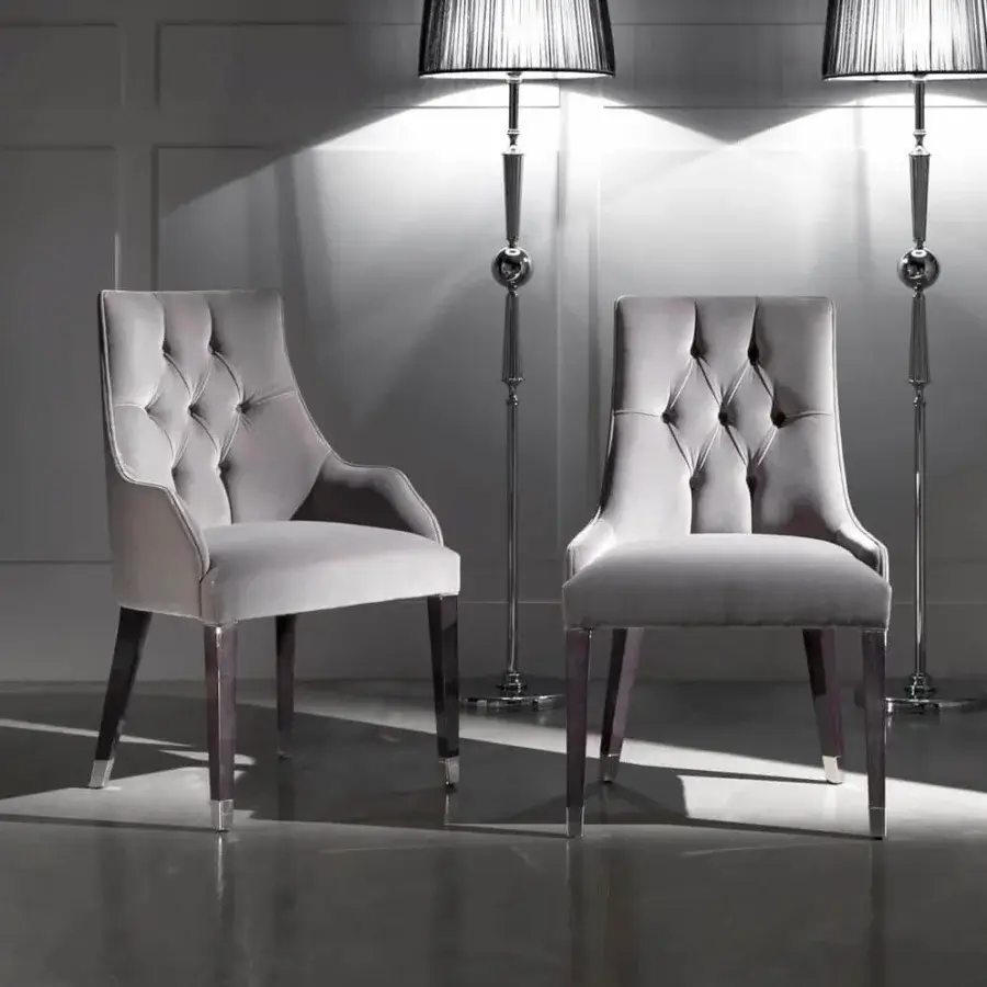Exceptional DV Home Collection Byron chair with matte grey textile and button-tufted backrest built with dark-toned wood legs capped in silver metal