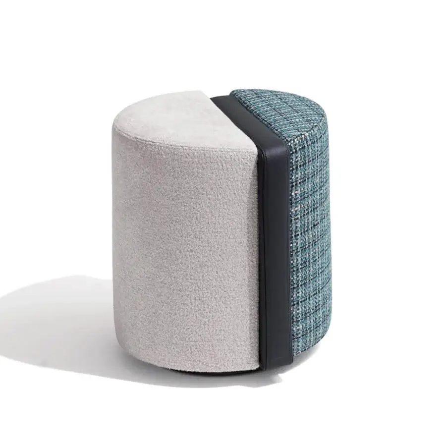 Exclusive Giorgetti Summa ottoman presenting cylinder form with textured textile and blue-white patterned weave with central leather element