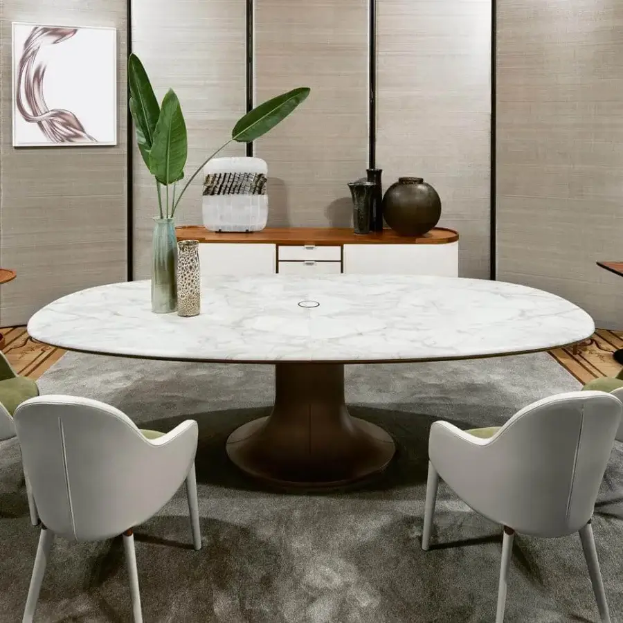 Distinguished Giorgetti Mizar table with an asymmetric oval marble top and cast bronze base crafted in a matching shade