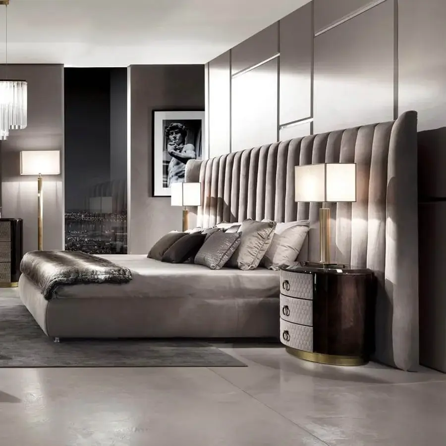 Lavish DV Home Collection Hermes bed with quilted headboard and dark wood bedside tables in gold accents