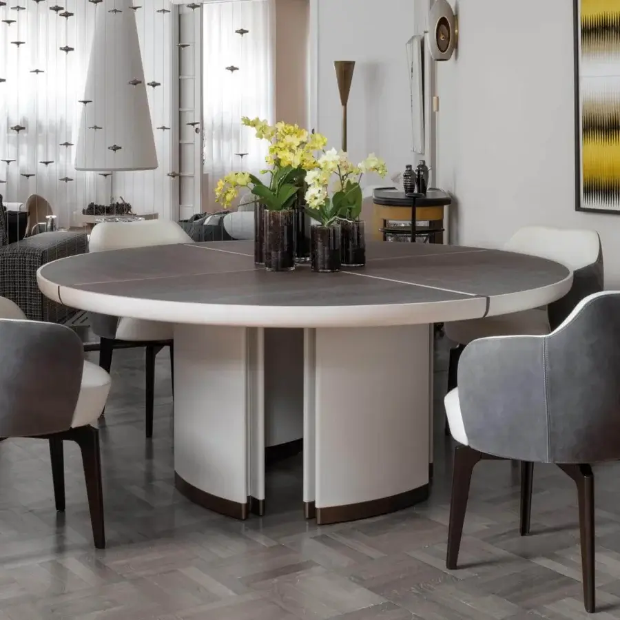 Distinguished Giorgetti Gordon table with dark tabletop and saddle leather-covered base columns in bronze painted details and contrasting finishes