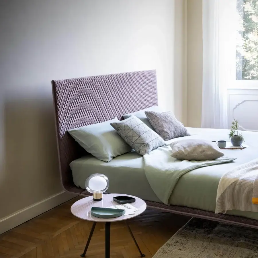 Elegant Bonaldo Thin bed with quilted diamond pattern in muted lavender textile and continuous linear design