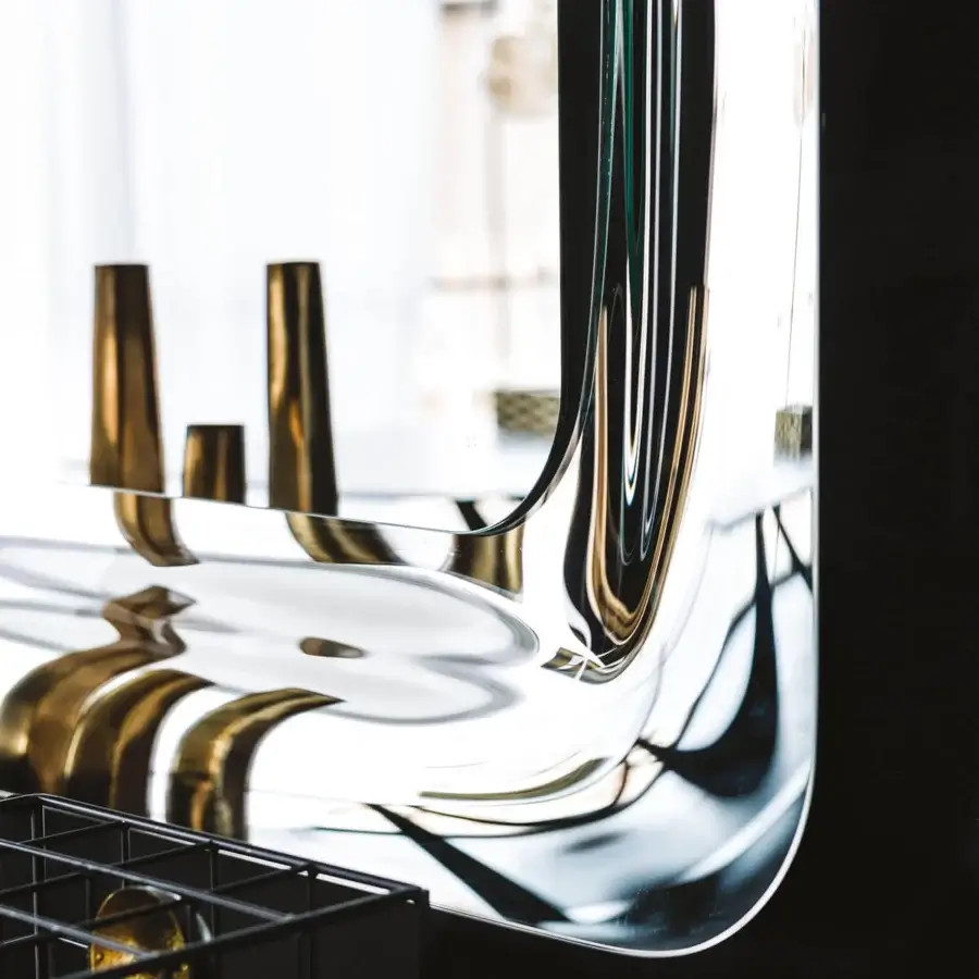 Distinguished Cattelan Italia Glenn mirror with mirrored glass frame and sleek contemporary curved silhouette