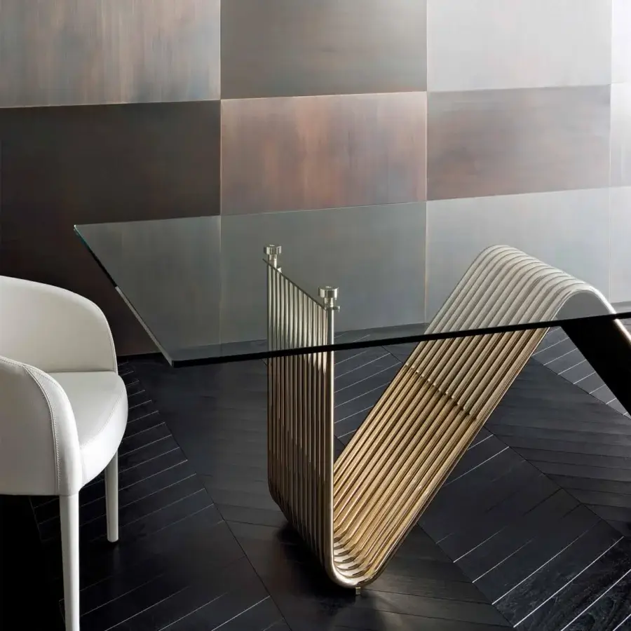 Innovative Rugiano Alyson table with a rectangular glass top and light gold metal base crafted in flowing curved shapes