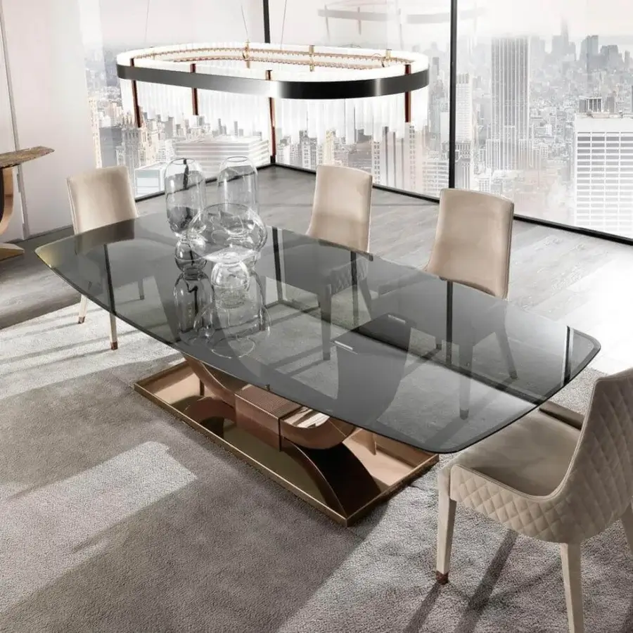 Innovative DV Home Collection Heritage table with golden stainless steel base and grey tinted rectangular glass top