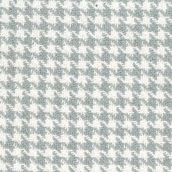 Crocheted mamba fabric texture, beige and gray-green, diagonal star pattern with visible stitches, dense houndstooth effect, Mariani brand.