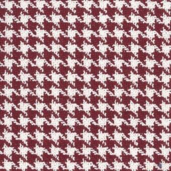 Mariani Mamba textile, burgundy floral pattern, creamy white motifs, woven fabric, dark lines, organic texture, studio shot.