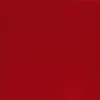 Deep red velveteen fabric with a short, uniform pile and smooth surface fills the frame, exhibiting consistent color and diffused lighting.
