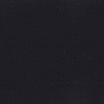 Dark gray velveteen fabric sample with a matte finish and subtle texture, displaying a directional nap and slight tonal variations throughout.