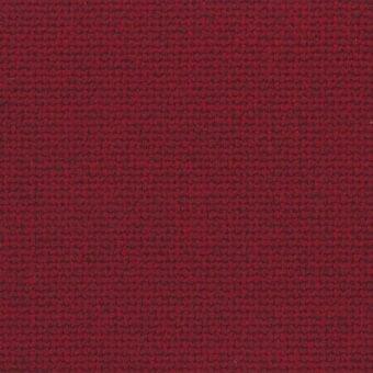 Red woven fabric texture with a dense, irregular pattern of dark fibers, exhibiting a nubby surface and uniform weave structure.