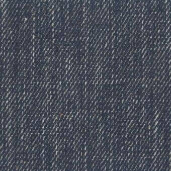 Navy blue woven textile with diagonal off-white pattern, subtle orange flecks, and a coarse, nubby texture; “Nadir” text integrated diagonally.