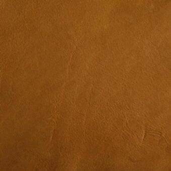 Brown leather texture sample displaying a grained surface, subtle distressing, and natural markings with imprinted “mariani” brand text.
