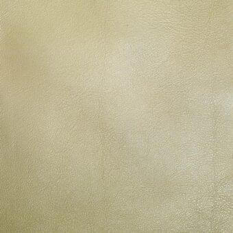 Leather texture sample, pale gold, finely pebbled grain with subtle creases, matte finish, even lighting, uniform background.