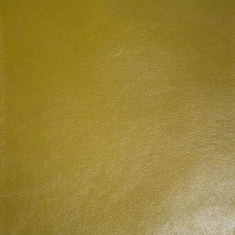 Leather upholstery, muted mustard yellow, mottled grain texture with subtle surface variations and imprinted brand text.