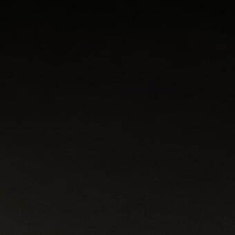 Dark gradient texture, nearly black, with a smooth woven or subtly textured material and uniform composition throughout the frame.