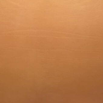 Dakota camel vegetable-tanned saddle leather with a matte finish, displaying horizontal linear creases and a subtly textured surface.