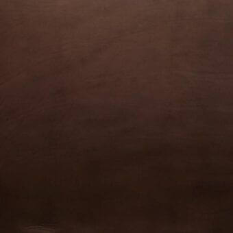 Dark brown saddle leather texture, vegetable tanned with mottled grain and linear markings, displaying a matte, refined finish.