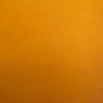 Vegetable-tanned saddle leather texture displaying a saturated orange color, matte finish, and natural grain with subtle tonal variations.