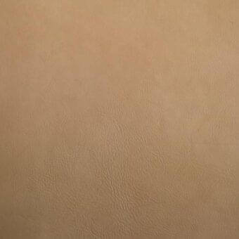 Vegetable-tanned saddle leather texture, light tan with mottled surface, irregular wrinkles, matte finish, and varied grain pattern.