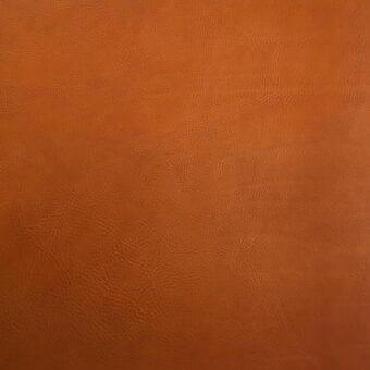Vegetable-tanned saddle leather texture in warm brown, displaying a pebbled grain and matte finish with subtle tonal variations and fine creases.