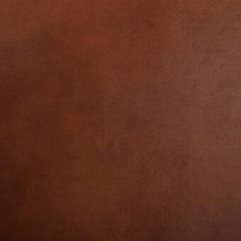 Vegetable-tanned saddle leather texture, warm brown color, dense grain pattern with subtle wrinkles, matte finish, handcrafted quality.