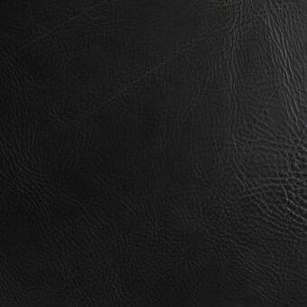 Black saddle leather texture, vegetable-tanned with dense wrinkles and a matte finish, displaying natural grain and subtle surface variations.