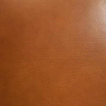 Vegetable-tanned saddle leather, rich brown color, full-grain texture with subtle sheen and horizontal line detail.