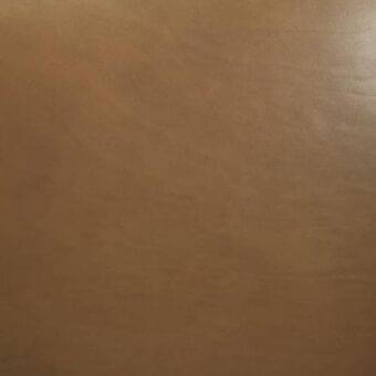 Vegetable-tanned saddle leather, medium brown, seamless matte texture with fine grain, studio lighting, natural tonal variations.