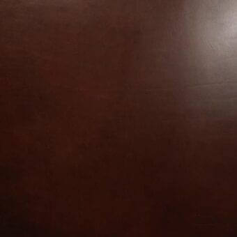 Vegetable-tanned saddle leather texture, dark brown, smooth matte finish with natural grain and subtle tonal variations, showcasing leather depth.