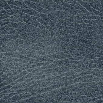 Dark gray full-grain leather texture with wrinkled surface, matte finish, and embossed “arketipo cuoio tribe 1034” branding in the lower right.