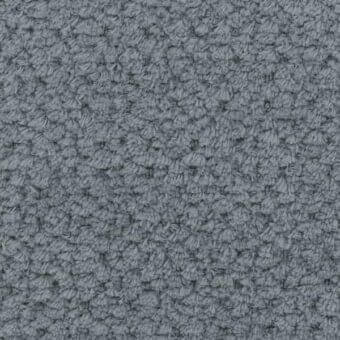 Dense looped gray fabric texture with a nubby, raised surface and uniform pattern, appearing matte and suitable for upholstery.