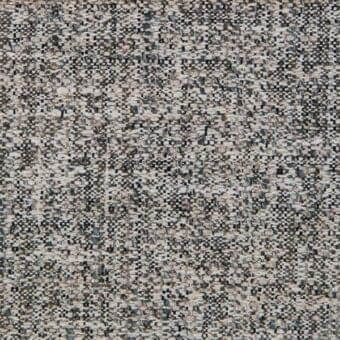Woven fabric sample, muted gray and beige with brown and blue threads, dense irregular weave, tactile surface, indoor textile.