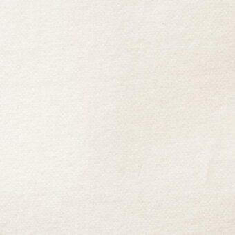 Off-white woven fabric sample with granular texture, matte finish, and subtle tonal variations; Arketipo brand label visible.