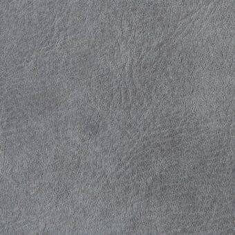 Gray fabric texture with dense pile, exhibiting subtle swirling patterns and a matte finish, creating a soft, plush visual appearance.