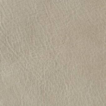 Distressed leather texture sample in light gray showcases irregular cracks, matte finish, and subtle shading; imprinted text reads “arketipo > leather > pelle a > 110030002611”.