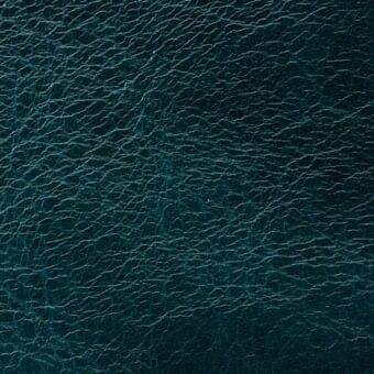 Teal leather texture, Arketipo “pelle leonardo” 110030001002, matte finish with creased, undulating pattern and tonal variations.
