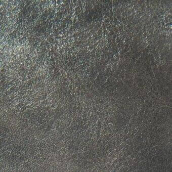 Dark gray Arketipo "pelle leonardo" leather texture, model 110030001011, displays a fine granular pattern and matte finish with tonal variation.
