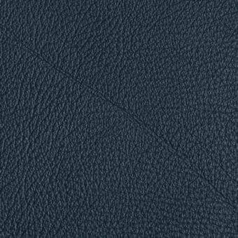 Dark blue leather texture, “arketipo pelle plus,” displays a dense, irregular grain with a subtly pebbled, matte finish.