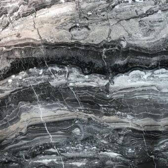 Arabesque Grey marble texture displaying swirling grey, black, and beige bands with white veins, polished finish, and natural stone imperfections.