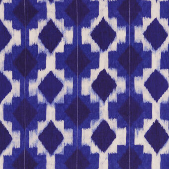 Belmondo fabric, deep blue geometric pattern with interlocking diamonds, indigo dye effect, subtle vertical lines, textured artisanal weave.