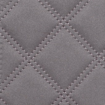 Gray quilted fabric displaying a diamond pattern, soft velvety texture, geometric stitching, monochromatic tone, matte finish upholstery material.