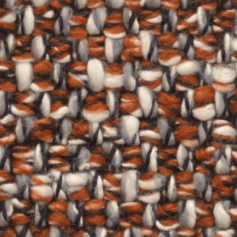 Woven tweed texture with warm orange, creamy white, and dark gray strands in a repeating, nubby pattern of horizontal and vertical threads.