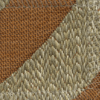 Woven fabric texture sample displaying brown grid pattern left, beige & cream looped pile right, studio lighting.